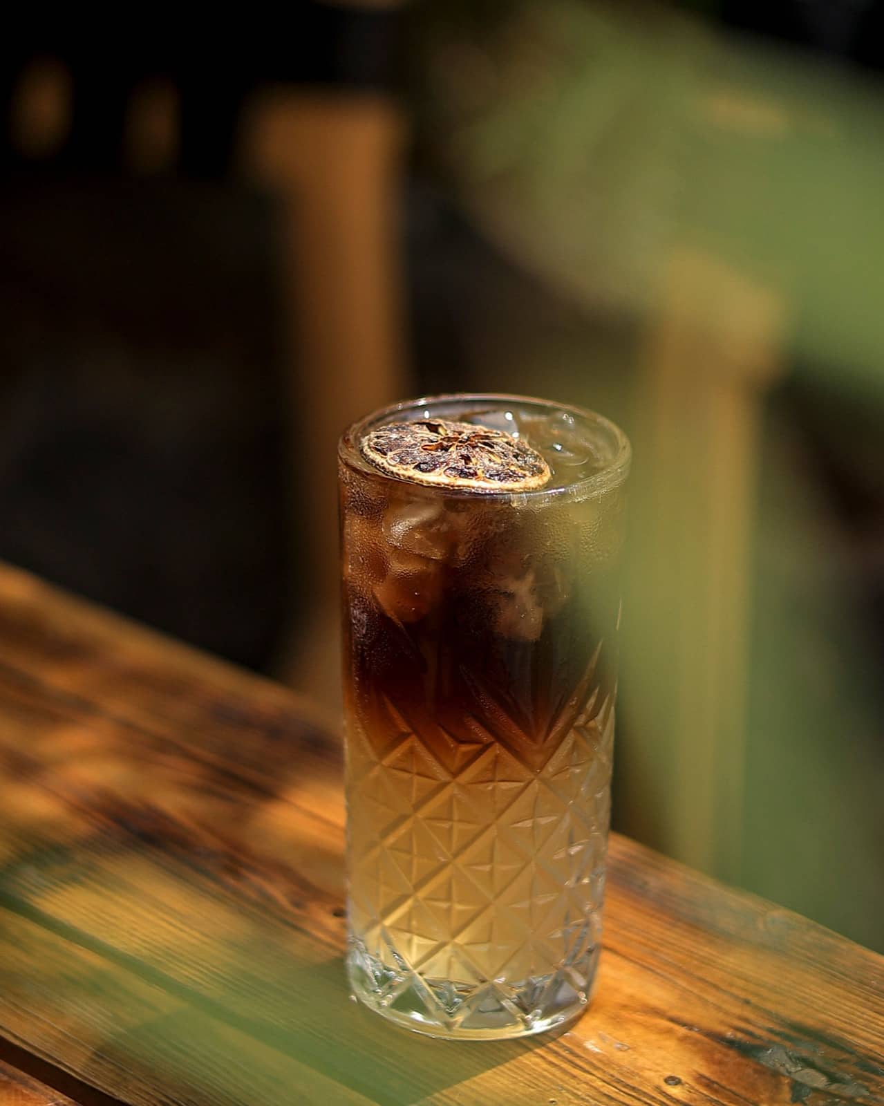 Iced coffee in a cut-glass tumbler in warm light