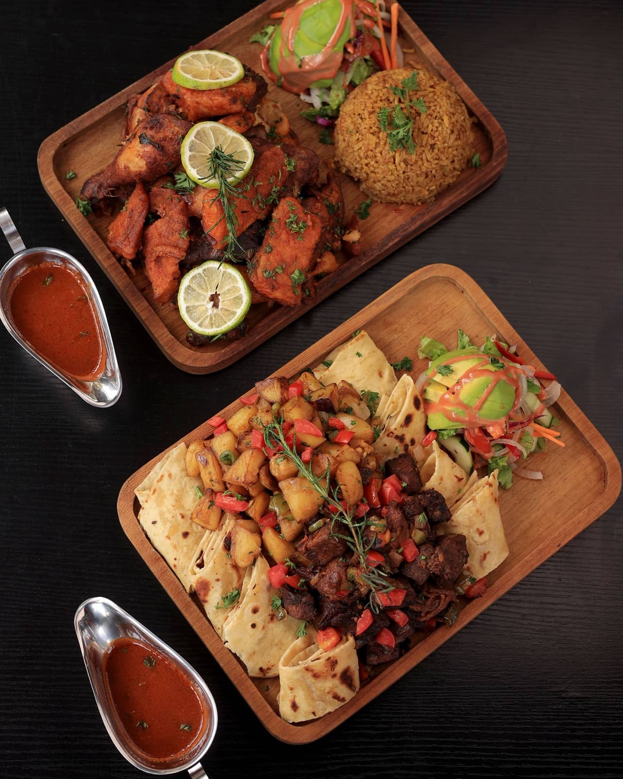 Two sharing boards: grilled chicken with pilau, and goat with chapati