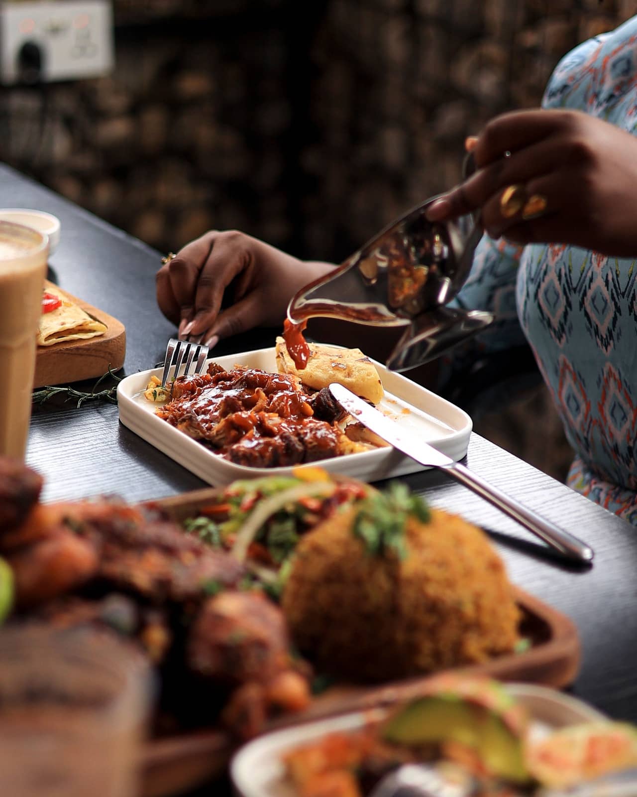 Sauce being poured over a plate at the table